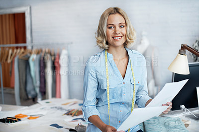 Buy stock photo A gorgeous young designer holding her designs while smiling at the camera