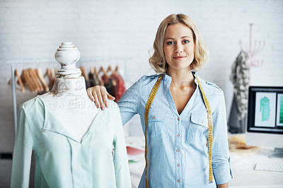 Buy stock photo A gorgeous young desinger standing next to her mannequin