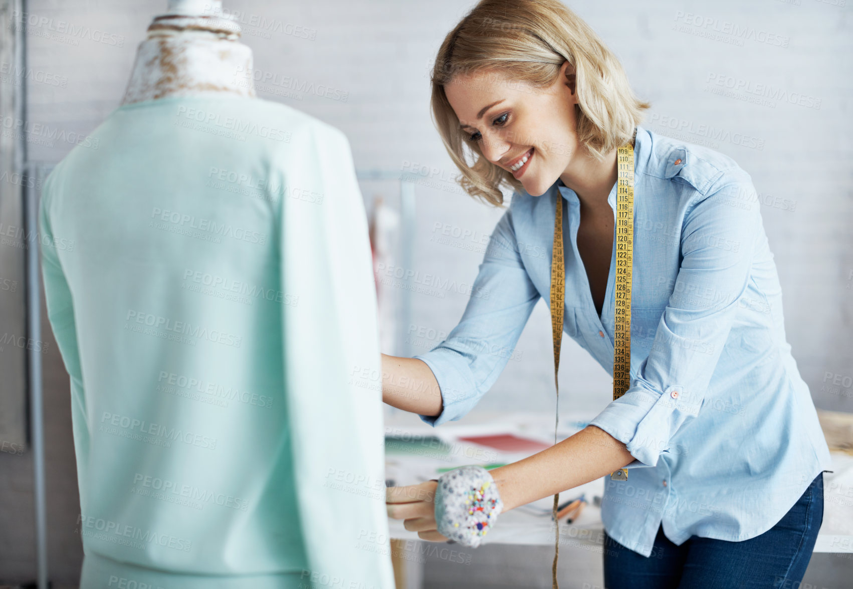 Buy stock photo A gorgeous young dressmaker working on her design on a mannequin