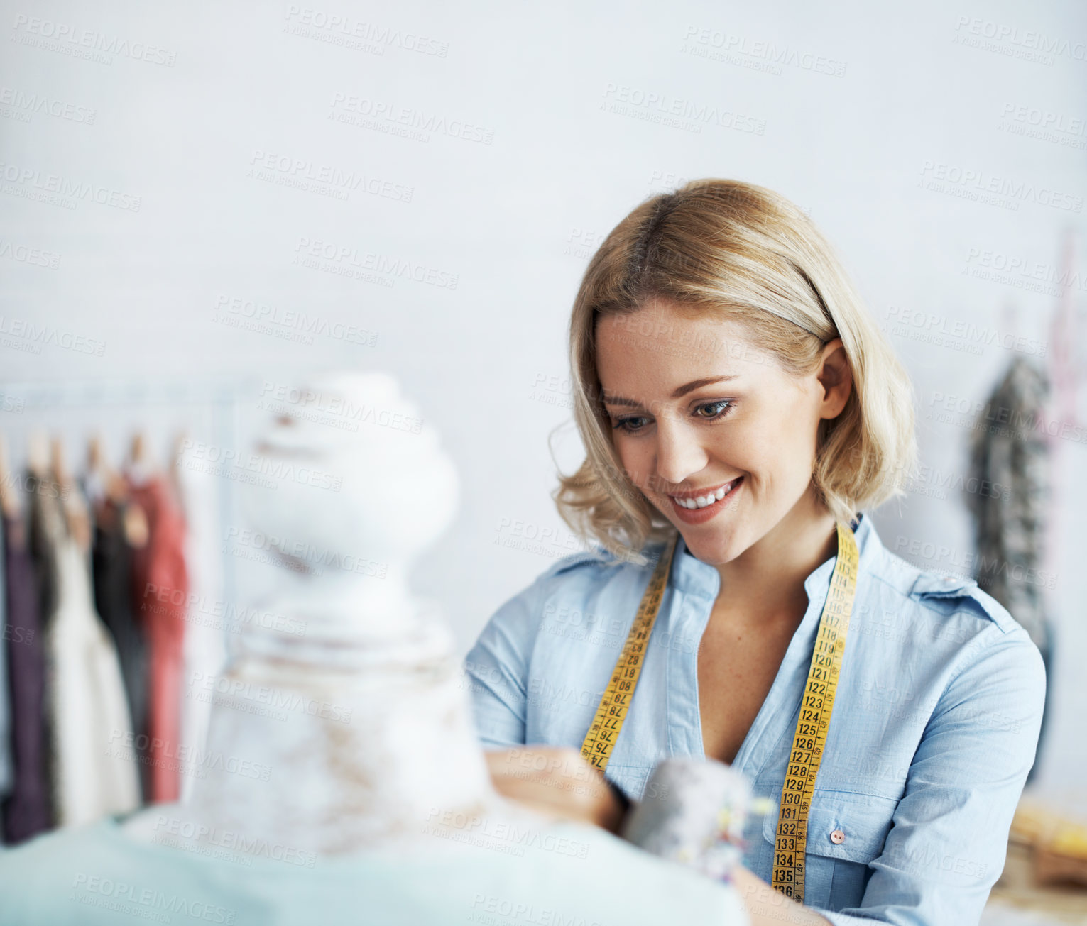 Buy stock photo A gorgeous young dressmaker working on her design on a mannequin