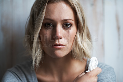 Buy stock photo Portrait of a pretty young blonde woman with mascara running down her face after crying