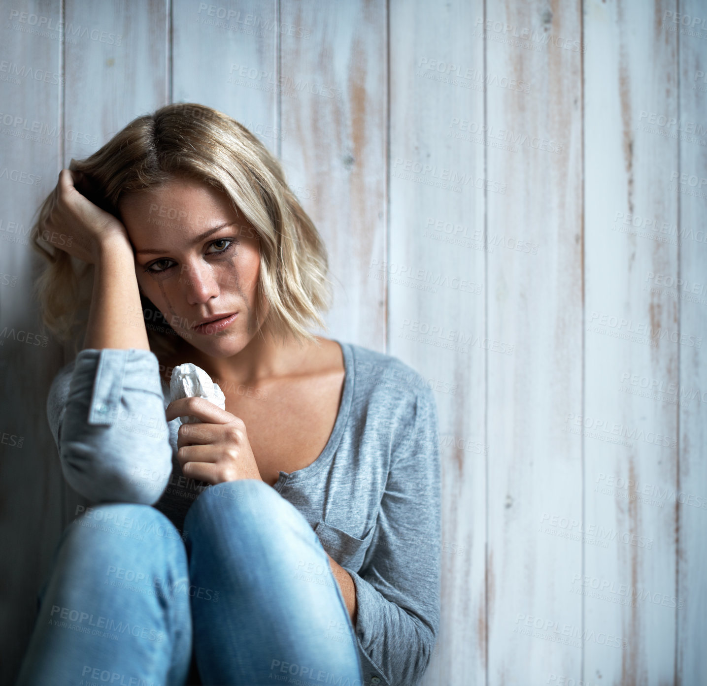 Buy stock photo Fear, sad woman and crying portrait in home for domestic abuse, trauma anxiety and emotional grief. Mascara tears, tissue and person with depression from tragic experience, space and wall background