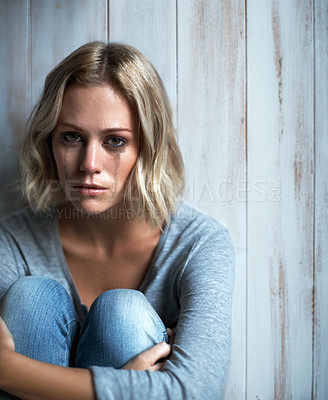 Buy stock photo Portrait of a young woman crying with mascara running down her face