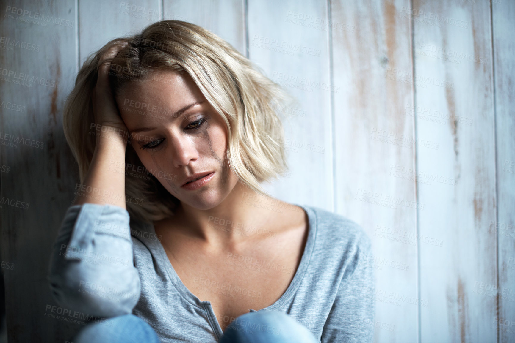 Buy stock photo Wooden wall, unhappy and woman with tears, pain and crying with anxiety and frustrated after mistake. Mental health, space and person with depression, grief and mourning with broken heart or regret