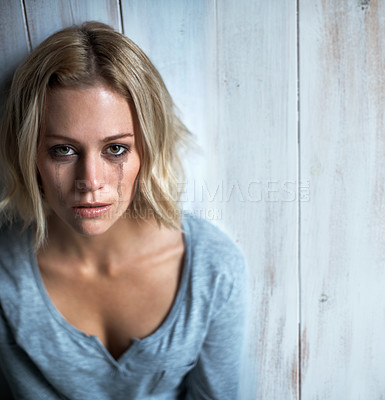 Buy stock photo High-angle view of a young woman with mascara tears running down her face