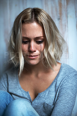 Buy stock photo A young blonde woman with mascara tears running down her face