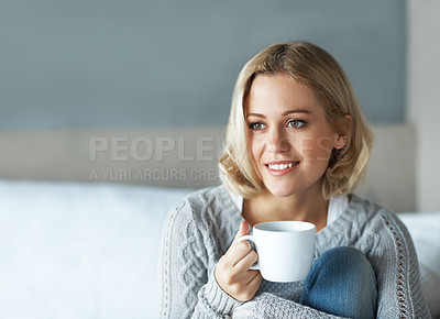 Buy stock photo A pretty young woman sitting at home and relaxing with a cup of coffee