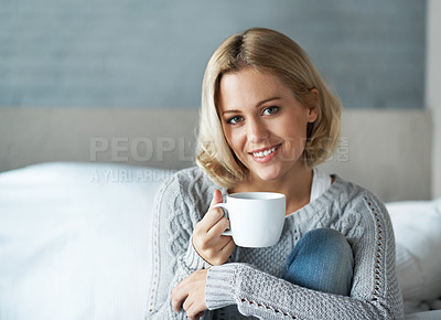 Buy stock photo Portrait of a beautiful blonde woman sitting at home with a cup of coffee