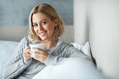 Buy stock photo Portrait of a young blonde woman drinking a cup of coffee at home