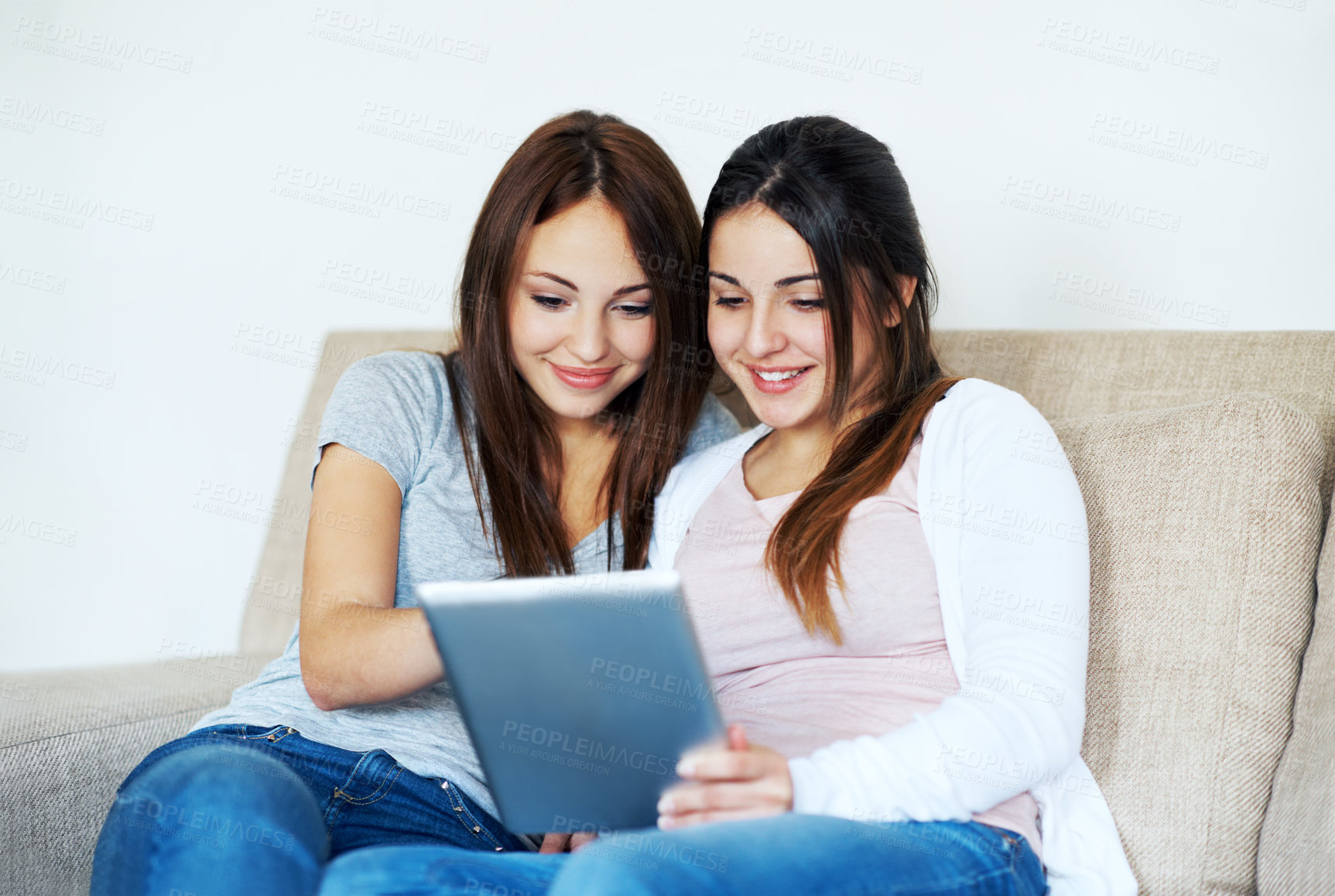 Buy stock photo Happy, teenager and siblings in home with tablet, relax and browsing social media app on weekend break. Girls, smile and sisters chill in living room with tech, reading blog or internet connectivity.
