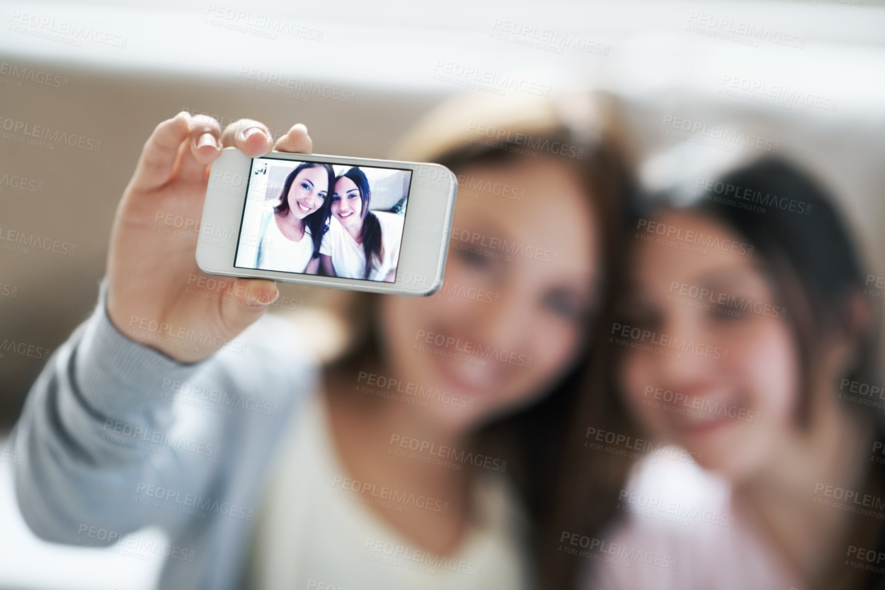 Buy stock photo Girls, friends and phone screen for selfie, vlog or profile picture together with facial expression in home. Happy, teenager and smile for photo, memory or funny online social media post in house