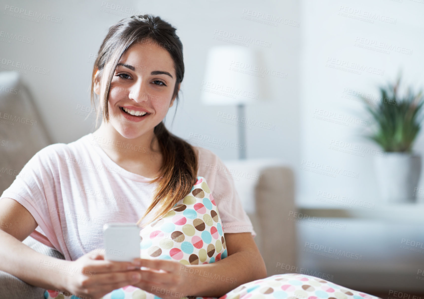 Buy stock photo Portrait, teenager and smile in home with phone, text message notification or internet for social media. Happy, girl relax and browsing in living room with tech, online entertainment and mobile chat.