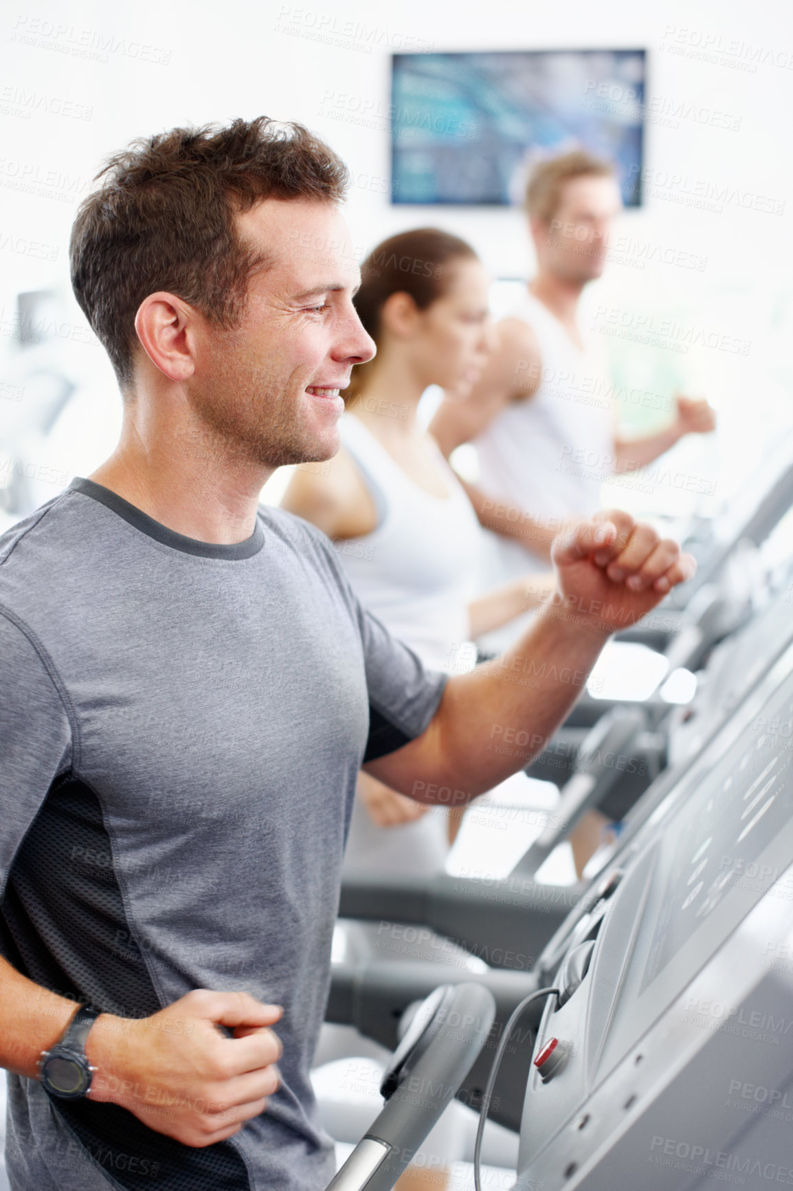 Buy stock photo Man, smile and running on treadmill with gym membership, workout and endurance training for wellness. Happy, person jog and runner in health club with equipment, pace and cardio exercise for fitness.