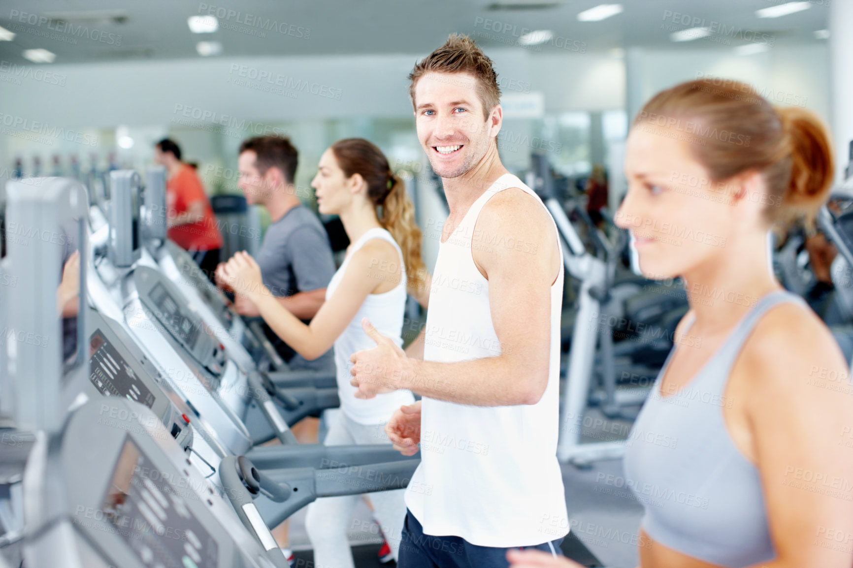 Buy stock photo Portrait, man and running on treadmill with gym membership, workout or smile for endurance training. Happy, person and runner in health club with equipment, wellness and cardio exercise for fitness.