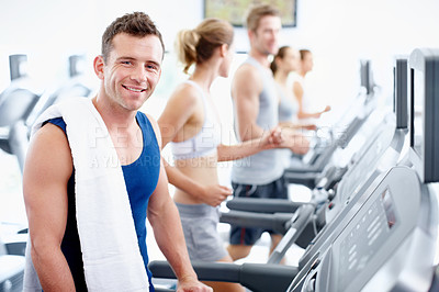 Buy stock photo Young man getting ready to use a treadmill at the gym