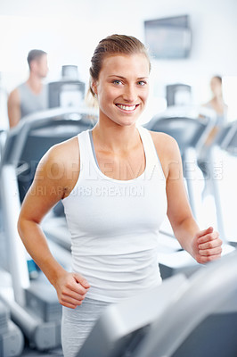 Buy stock photo Young woman jogging on a treadmill at the gym - portrait