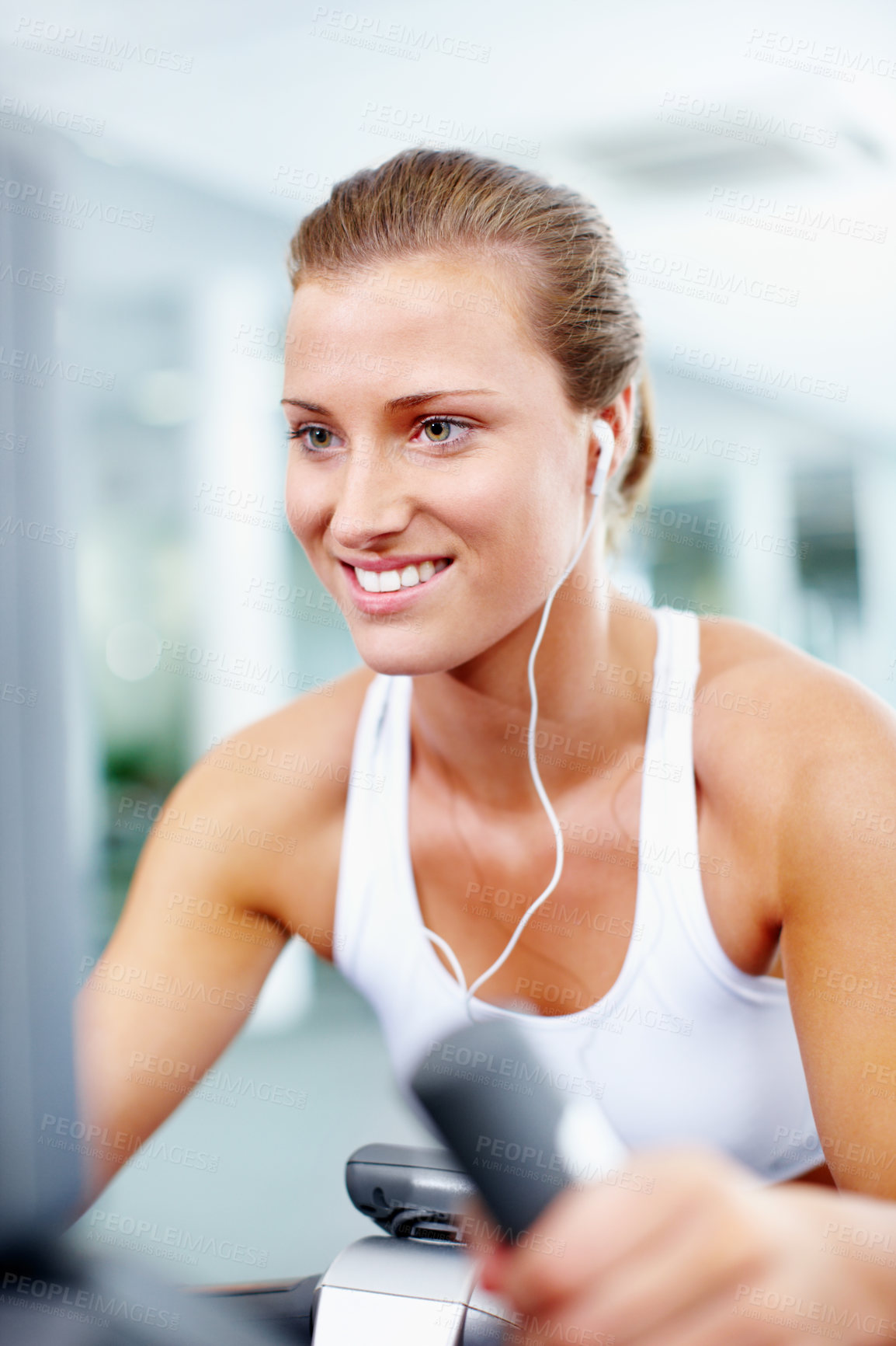 Buy stock photo Cycling, smile or woman in gym with earphones, training playlist or cardio exercise in fitness hobby. Happy, bike or person with tech, music subscription or resistance machine in spin activity.