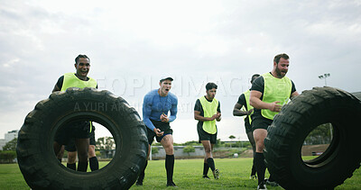 Buy stock photo Fitness, coach and team with tire on field, strength challenge and training for sport competition. Coaching, trainer or rugby players with exercise for muscle development, active men or weightlifting