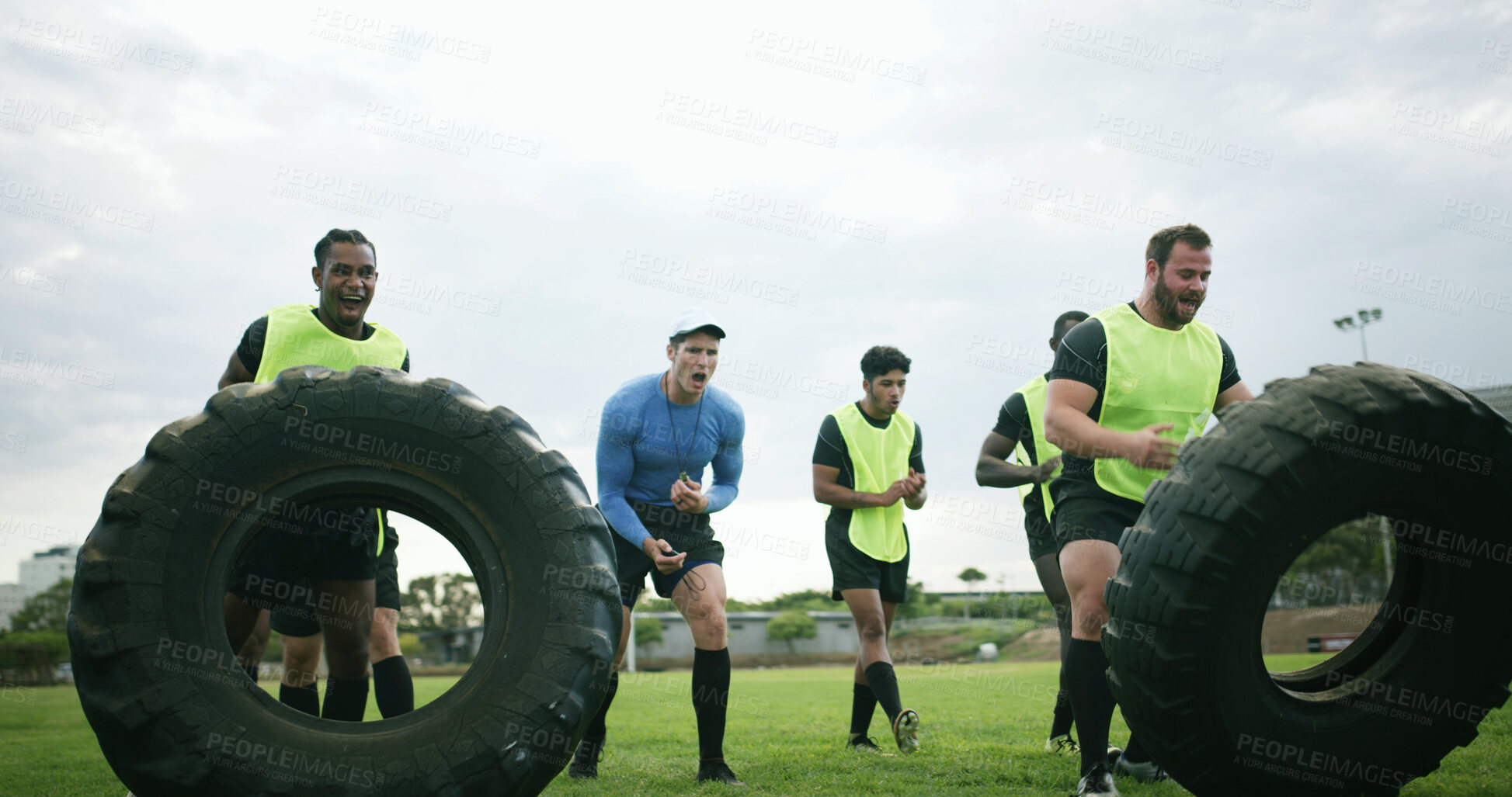 Buy stock photo Fitness, coach and team with tire on field, strength challenge and training for sport competition. Coaching, trainer or rugby players with exercise for muscle development, active men or weightlifting