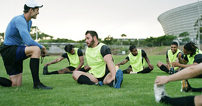 Buy stock photo Coach, stretching or team with practice on field, sports training or instructions for warm up routine. Outdoor, instructor and people with leg exercise for mobility, match preparation and rugby club