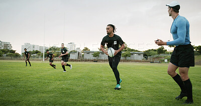 Buy stock photo Rugby, team and coach on field with practice, guidance and cardio exercise for competition outdoor. Instructor, men and running on grass with equipment, training and workout for sports performance.