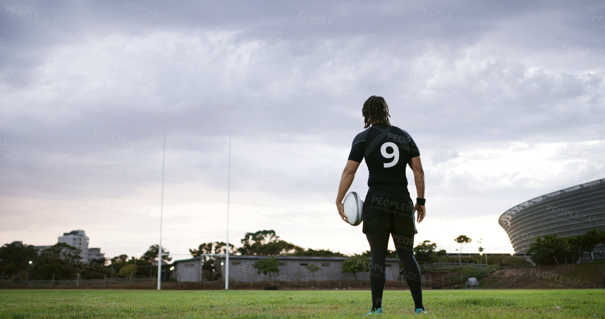 Buy stock photo Rugby, thinking or man on field with ball, goal mindset or daydreaming in fitness hobby. Reflection, back or player outdoor with space, athlete insight or performance perspective in collision sport.