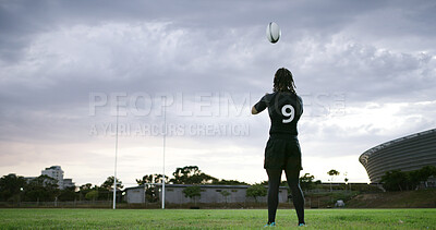 Buy stock photo Back, man and rugby player on field with ball, practice throwing technique or training for competition. Clouds, person and athlete outdoor with sports equipment, exercise and workout for fitness. 