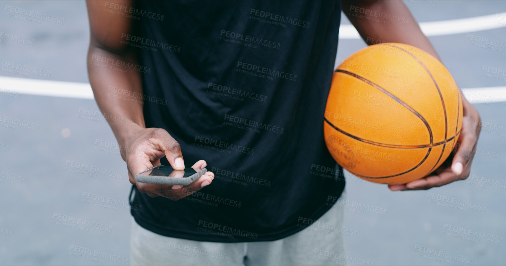 Buy stock photo Man, hands and basketball on court with phone, fitness app and research training tips for practice. Person, outdoor and scroll with tech for sports website, wellness or text message from social media