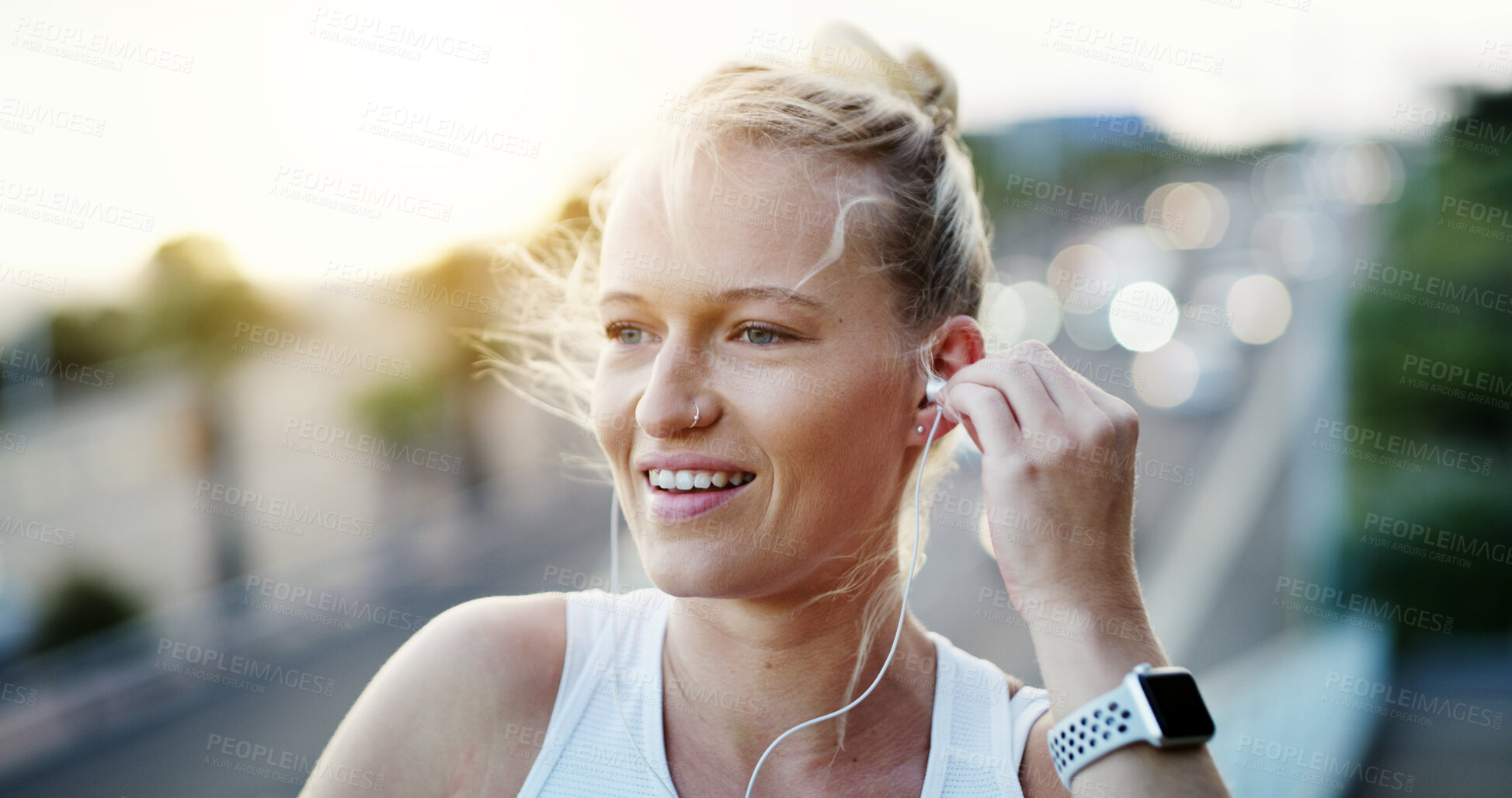 Buy stock photo Athlete, fitness and woman with earphones in city, wellness and listening to music with subscription. Outdoor, runner and happy person with health goals, online or streaming audio with tech on bridge