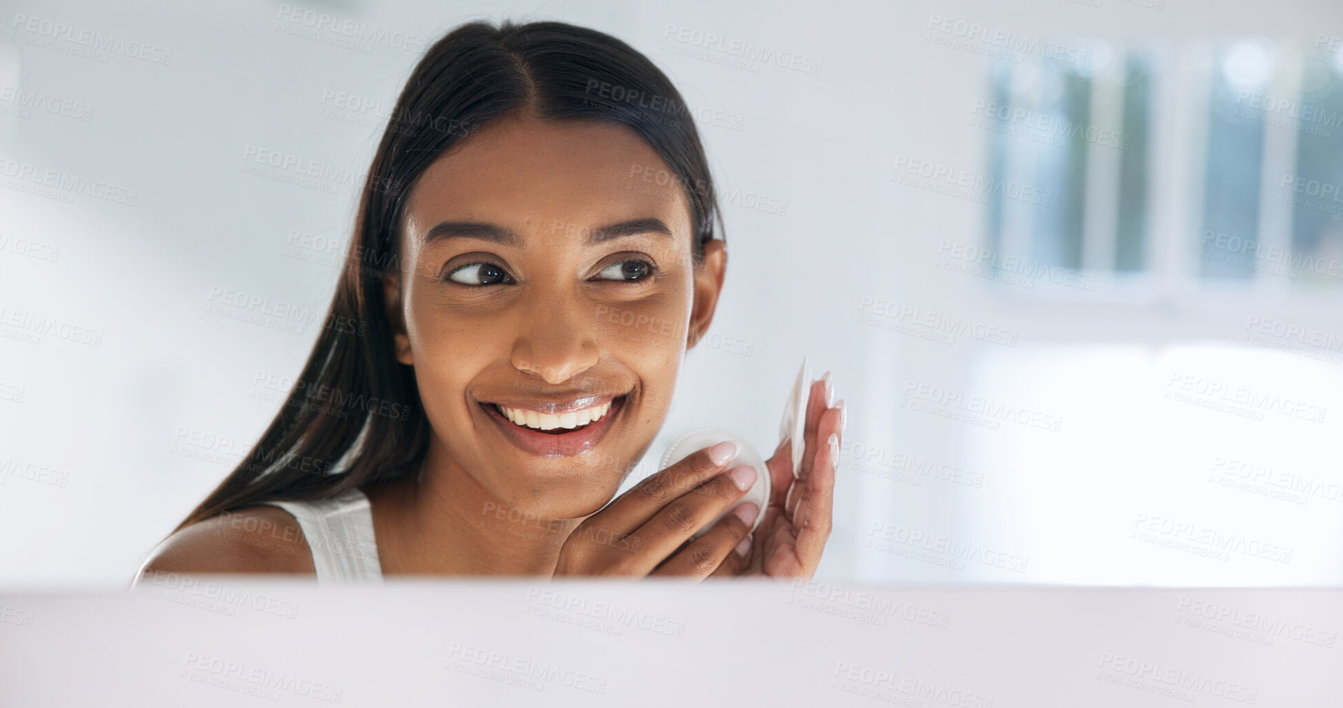 Buy stock photo Woman, mirror and cotton pad for skincare in home, cleaning or hygiene with makeup removal. Self care routine, happy person and reflection for dermatology with beauty in bathroom and cosmetics