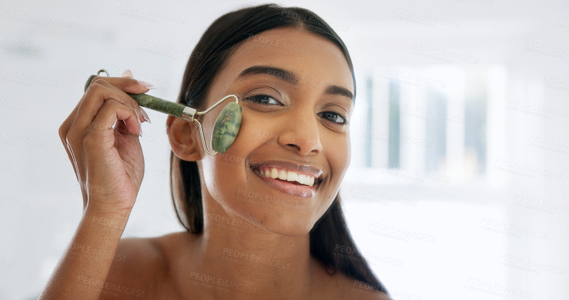 Buy stock photo Portrait, skincare or woman with jade roller in home, lymphatic drainage or beauty with glow. Bathroom, happy person and tool for facial massage for health, shine or dermatology benefits in morning