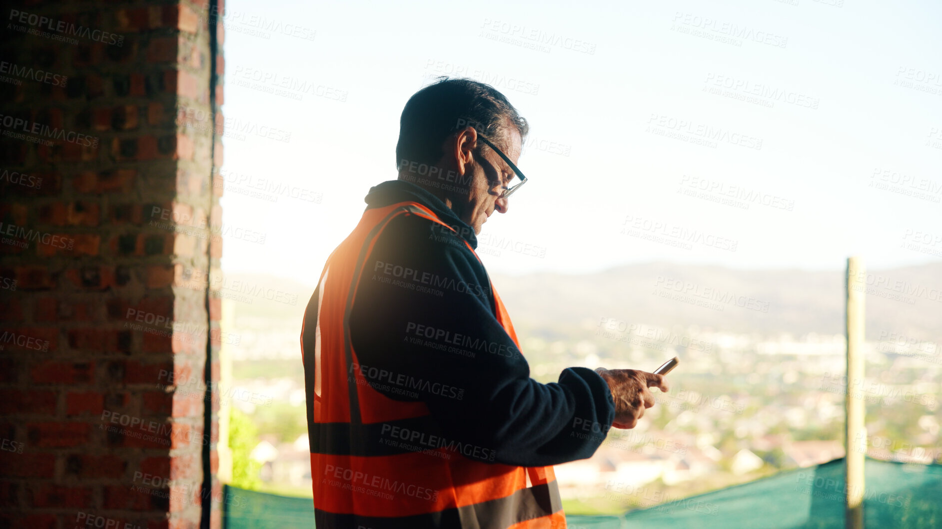 Buy stock photo Manager, construction and man with phone on site for timesheet review, safety log or texting. Foreman, mature person and mobile app in building for project communication, compliance checklist or chat