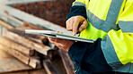 Person, hands and builder with tablet in construction site for building inspection or maintenance. Contractor, technology or checklist with material for civil engineering, inventory or safety check