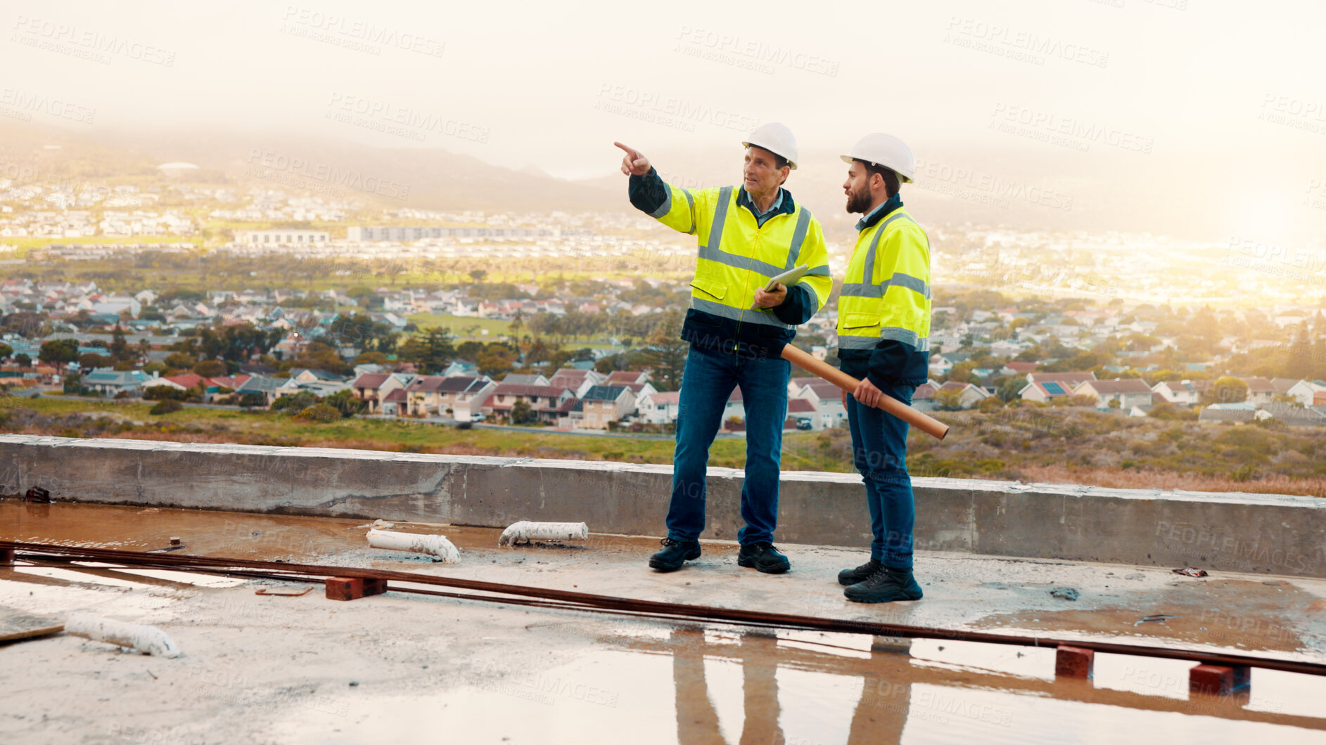 Buy stock photo Architect, pointing and men with inspection for construction quality, structural safety or teamwork. Tablet, blueprint and workers discussion on rooftop for site progress, compliance and architecture