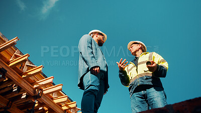Buy stock photo Construction, architect or talk to manager on roof for site inspection, building update or teamwork. Low angle, men and project foreman with blueprint for renovation progress, architecture and safety