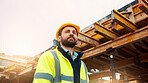 Engineer, man and thinking on construction site with helmet, quality assurance and building project. Low angle, person and reflection outdoor with engineering job, PPE and vision for infrastructure.