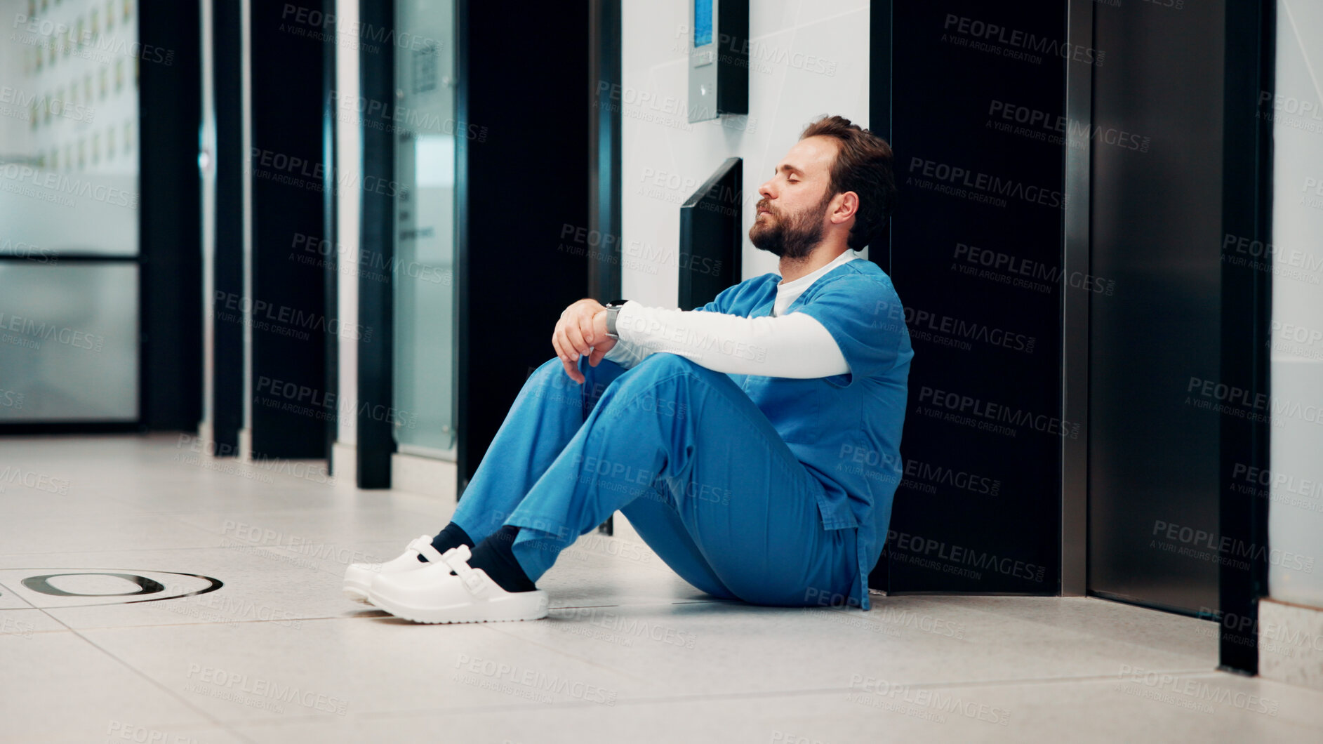 Buy stock photo Thinking, hallway and doctor on floor in hospital with burnout for mistake, surgery fail and patient loss. Healthcare, stress and man with worry, guilt and reflection for crisis in medical service