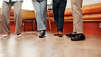 Legs, group and people in office for counseling, emotional support and rehabilitation program. Feet, staff or therapy session for conflict resolution, interaction activity and mental health guidance