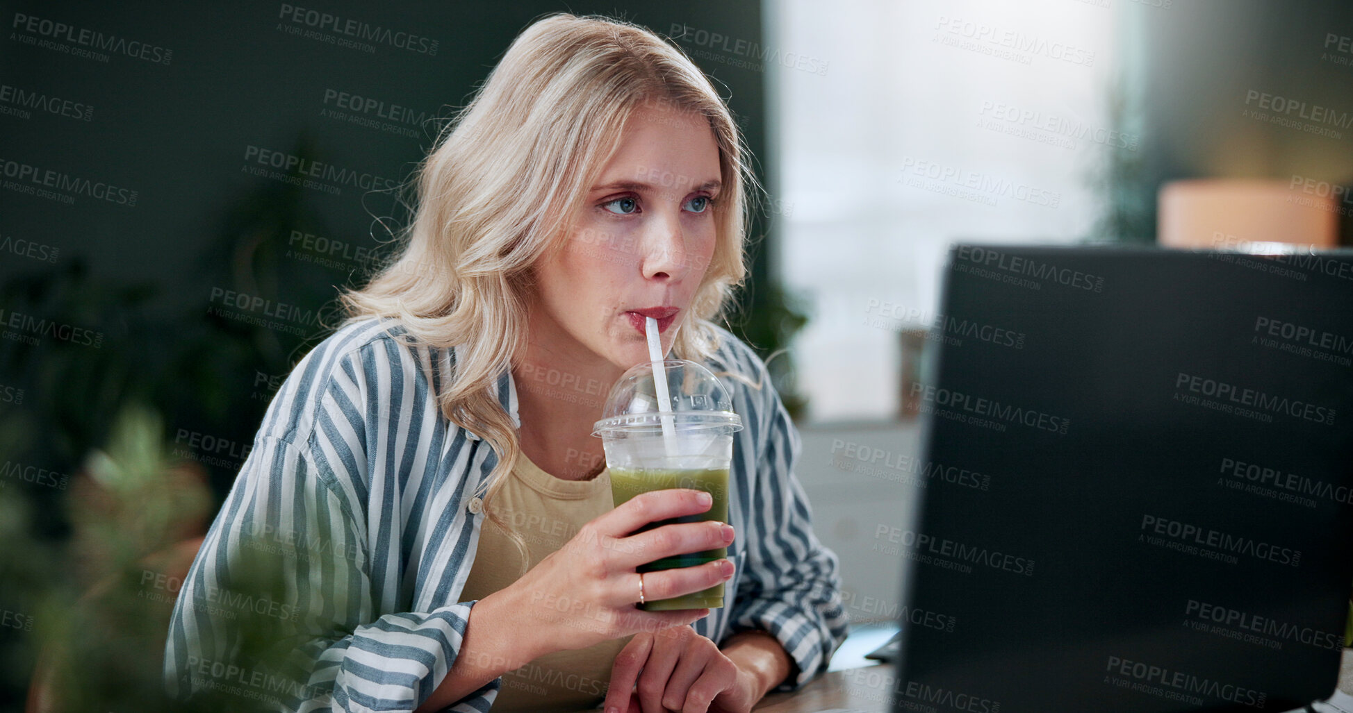 Buy stock photo Creative, woman and drink in office with laptop, review project and research for digital marketing. Female person, tech and reading in agency with smoothie beverage, proposal and advertising campaign