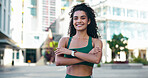 City, portrait and woman with arms crossed, fitness and confident with bodybuilding goal or wellness. Outdoor, athlete and person with smile after physical activity, break and pride for healthy body