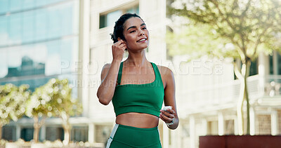 Buy stock photo Thinking, athlete and woman with earphones in city, smile and streaming music for physical activity. Outdoor, fitness and happy person with tech for sound, listening and subscription for playlist