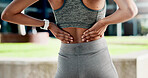 Hands, back pain and injury with fitness in city with muscle strain, fatigue and rest for wellness. Person, runner and outdoor with ache, fibromyalgia or exhausted on break for exercise in town