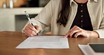 Hands, documents and signature in home with finances, agreement or admin for investment portfolio. Person, investor and paperwork with writing, tax compliance and application for insurance at house