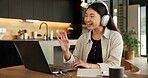 Happy woman, laptop and wave on video call for remote work from home, headphones or talk in lounge. Asian person, greeting and virtual meeting on pc, audio and smile with hello with feedback at house