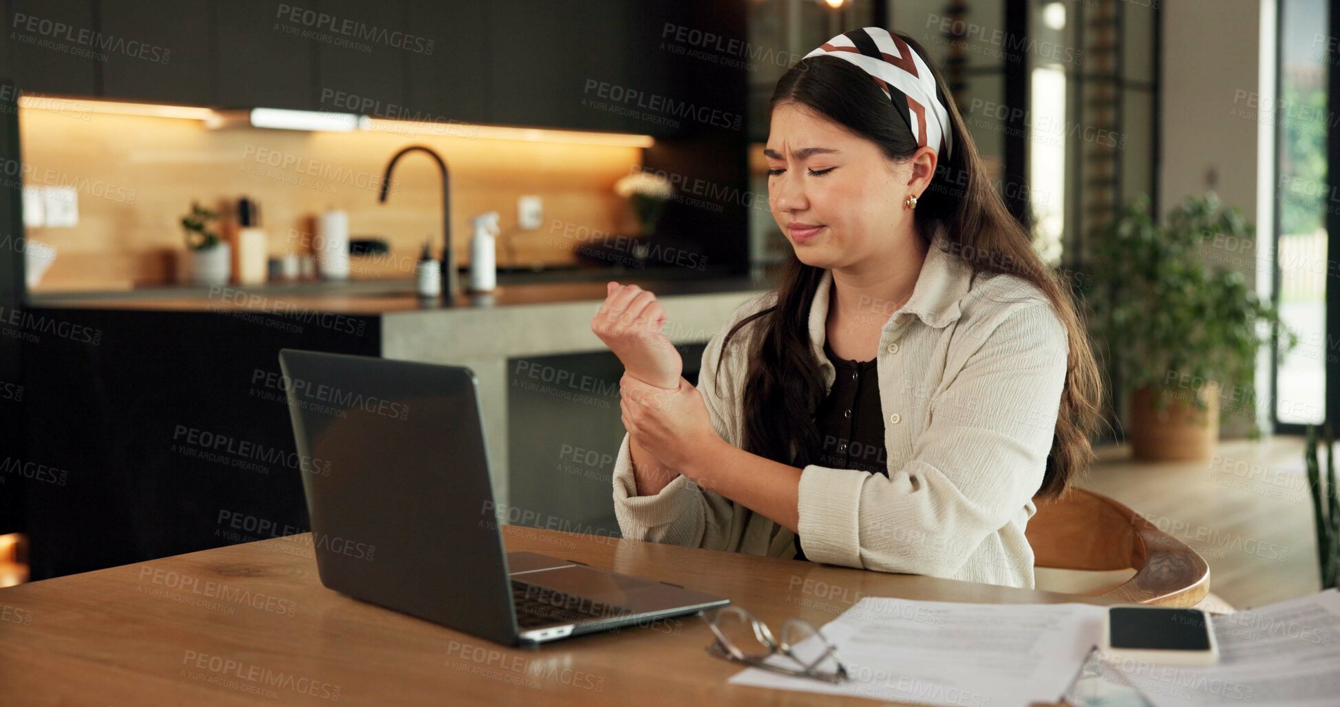 Buy stock photo Remote work, wrist pain and woman in home, laptop for online article and inflammation. Freelancer, writer and person in kitchen, arthritis or carpal tunnel syndrome with pressure and joint injury