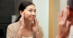 Mirror, smile and woman in bathroom for skincare, grooming and dermatology for healthy skin and glow. Reflection, check and Asian person in house, hygiene and self care with cosmetics for beauty