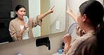 Singing, brush and woman by mirror in bathroom at house with music for getting ready or morning routine. Reflection, playlist and Asian female person with hair care tool for karaoke in apartment.