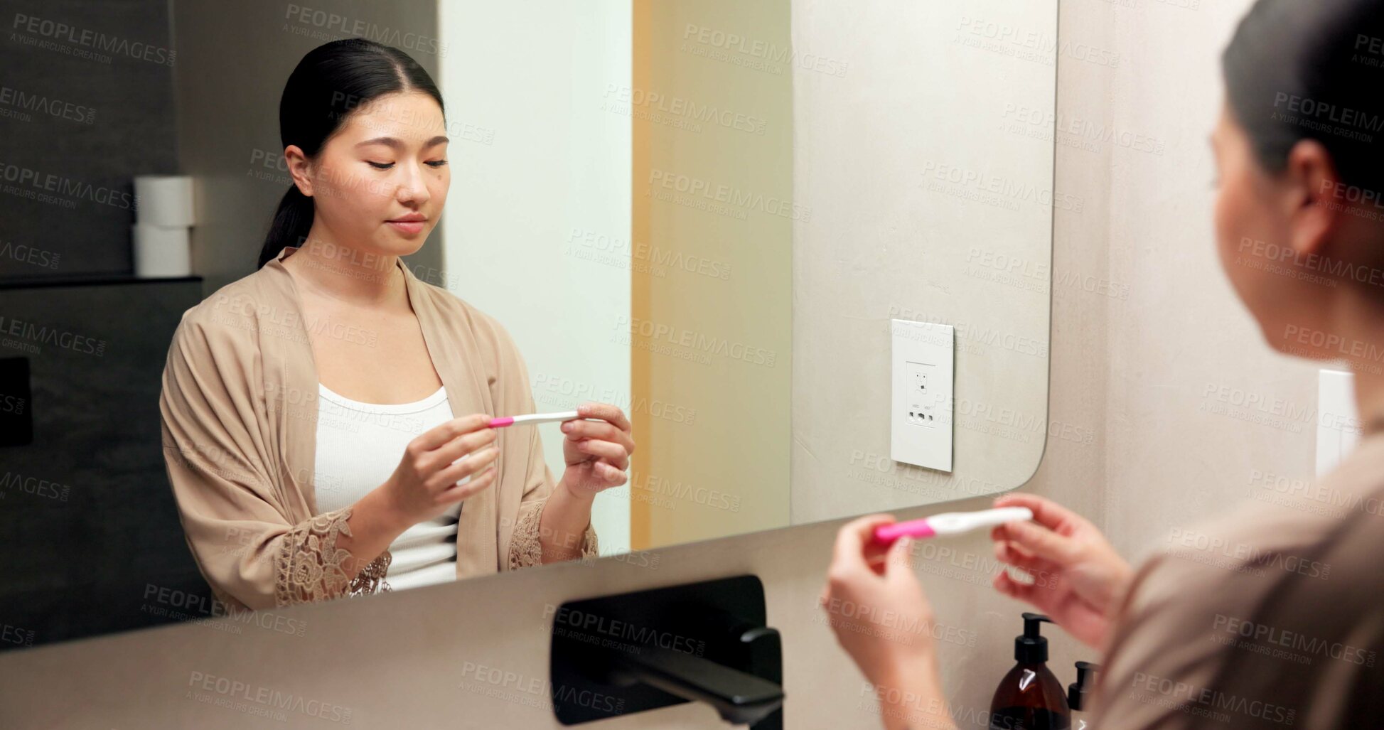 Buy stock photo Woman, pregnancy test and results in bathroom, home and check for fertility with thinking in morning. Asian person, monitor or stick for outcome, IVF and waiting at mirror with reflection in house