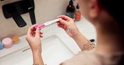 Buy stock photo Hands, pregnancy test and results in bathroom, home and check for fertility with screen in morning. Person, monitor or stick for outcome, IVF and urine sample at basin with waiting in apartment
