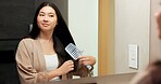 Mirror, beauty and woman brushing hair in bathroom for grooming, self care or morning routine. Happy, reflection and Asian female person with hairstyle for daily haircare treatment in apartment.